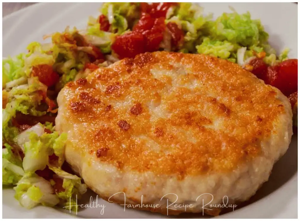 Pan fried chicken burger patty with side salad