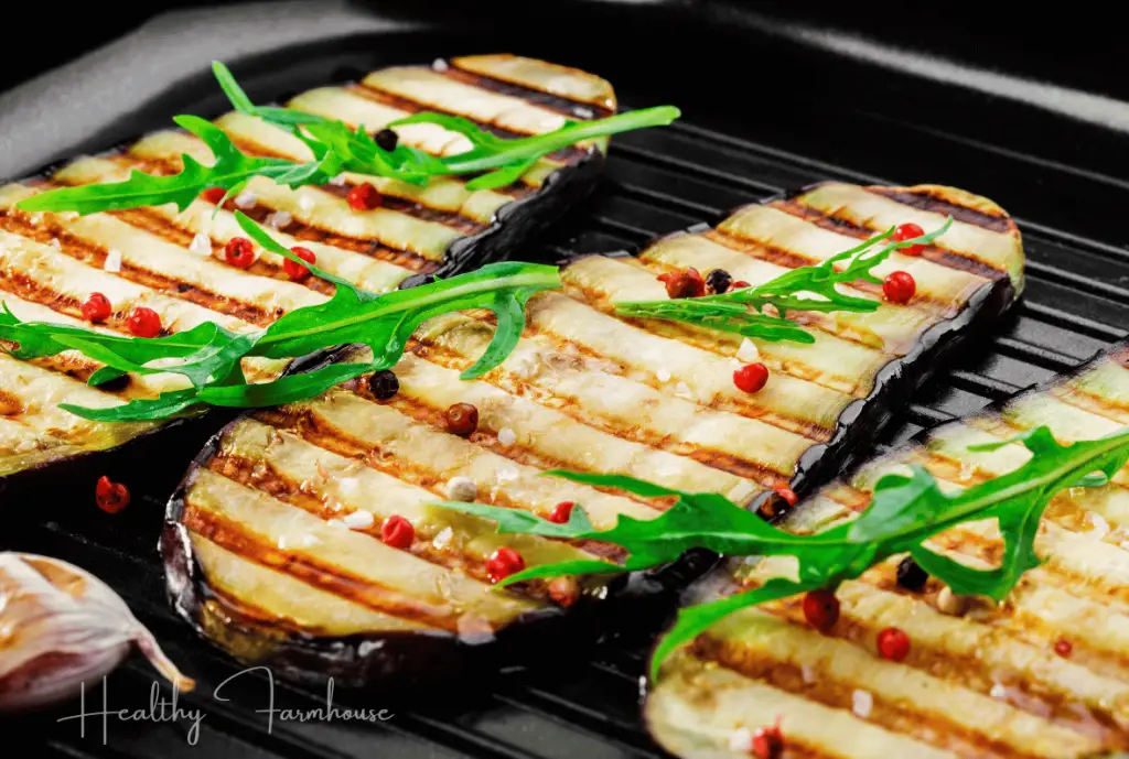 Grilled eggplan slices with greens.