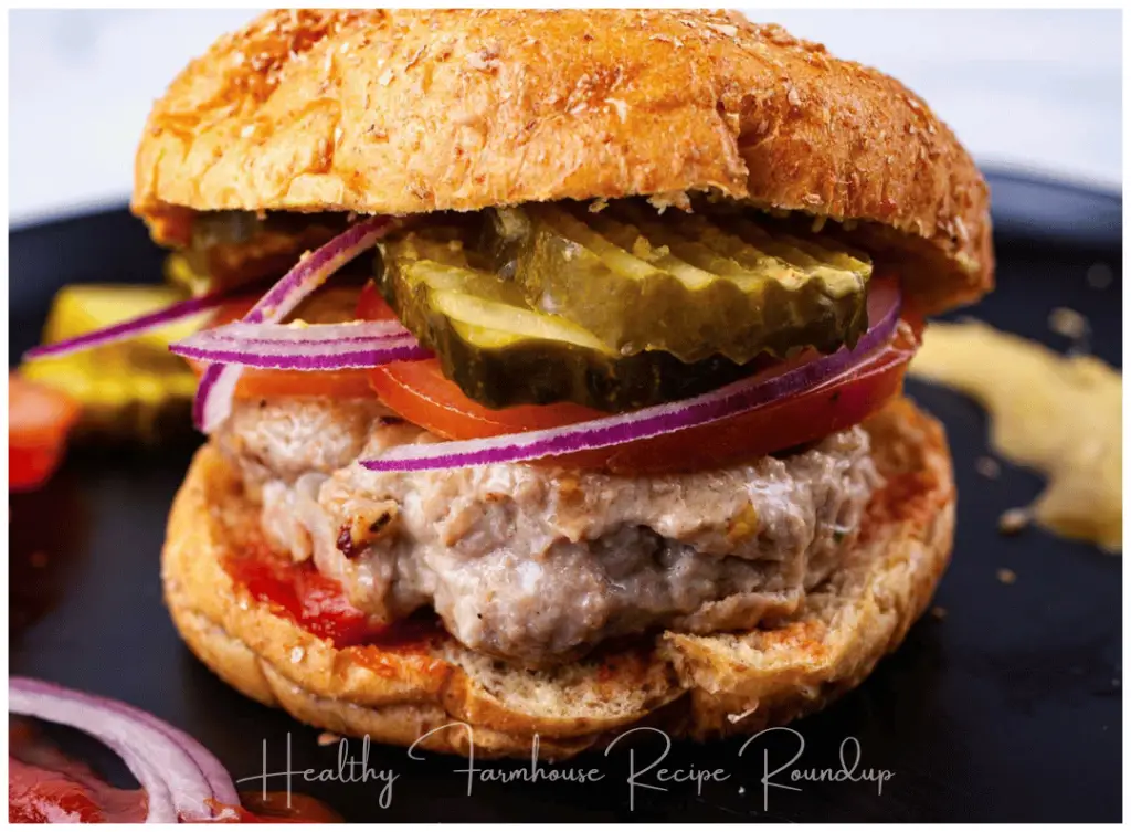 Healthy Italian turkey burger with pickles, onion, tomatoes, and a bun.