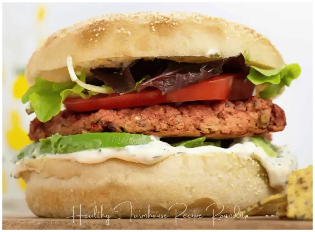 Healthy lentil and beetroot burger with lettuce, sauce, and bun
