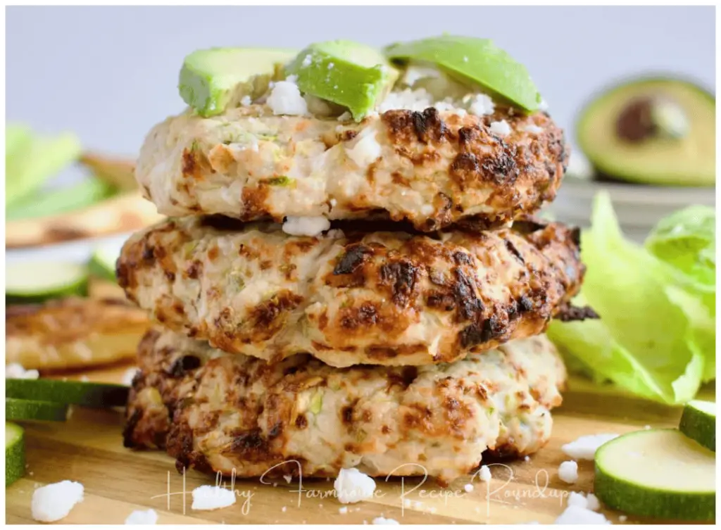 Stack of zucchini turkey burgers with avacado slices on top
