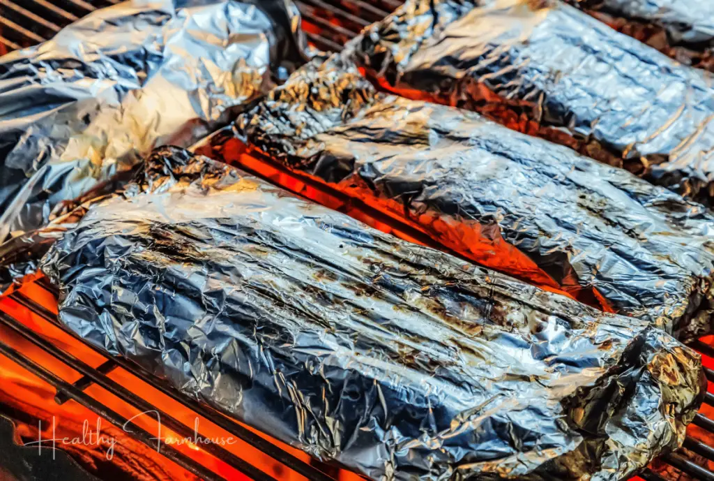 Aluminum foil wrapped good on grill grates