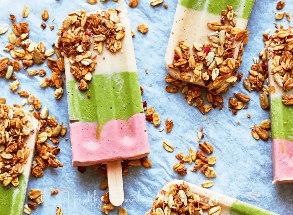 Pink and green striped fruit and veggie popsicle with granola