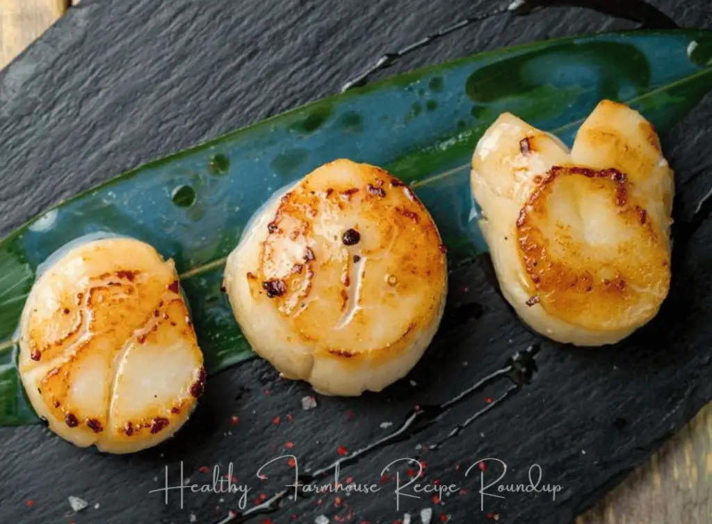 3 seafood scallops on a leaf
