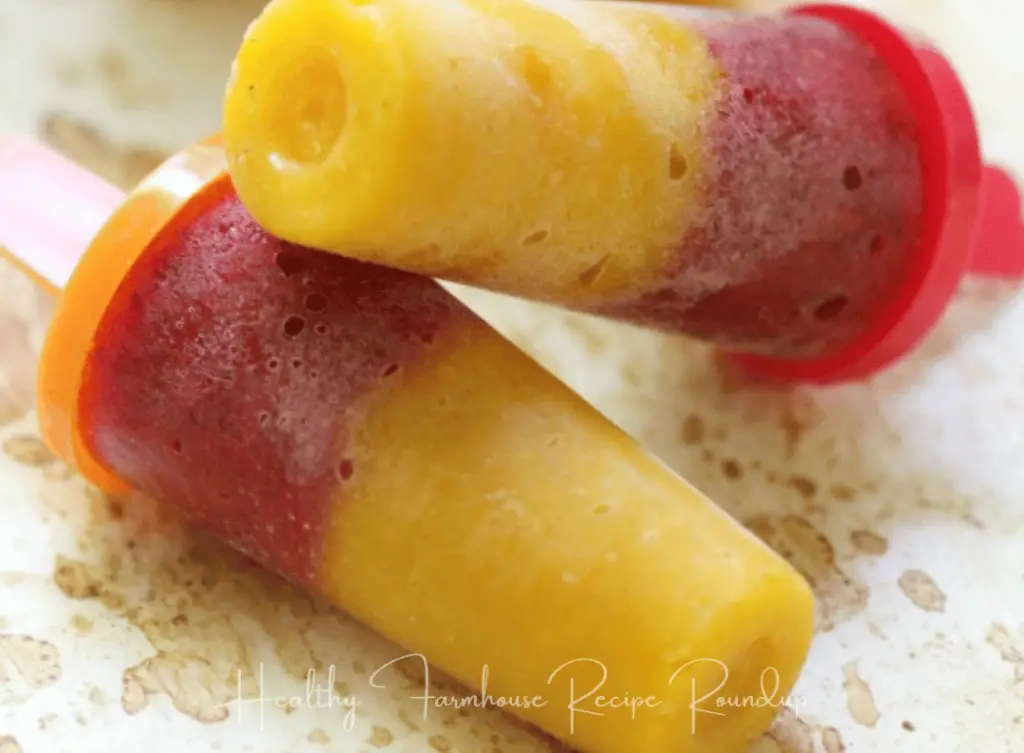 Yellow and red mango strawberry popsicle in plastic mold