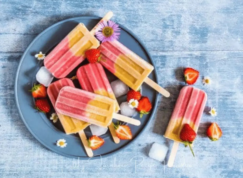 Yellow bottom, pink topped popsicles in bowl - strawberry popsicle recipes