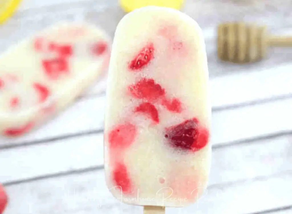White and red strawberry yogurt popsicle