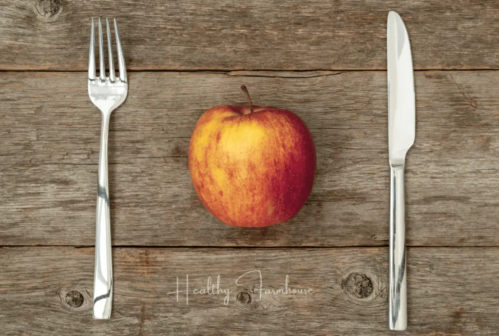 Apple with fork and knife