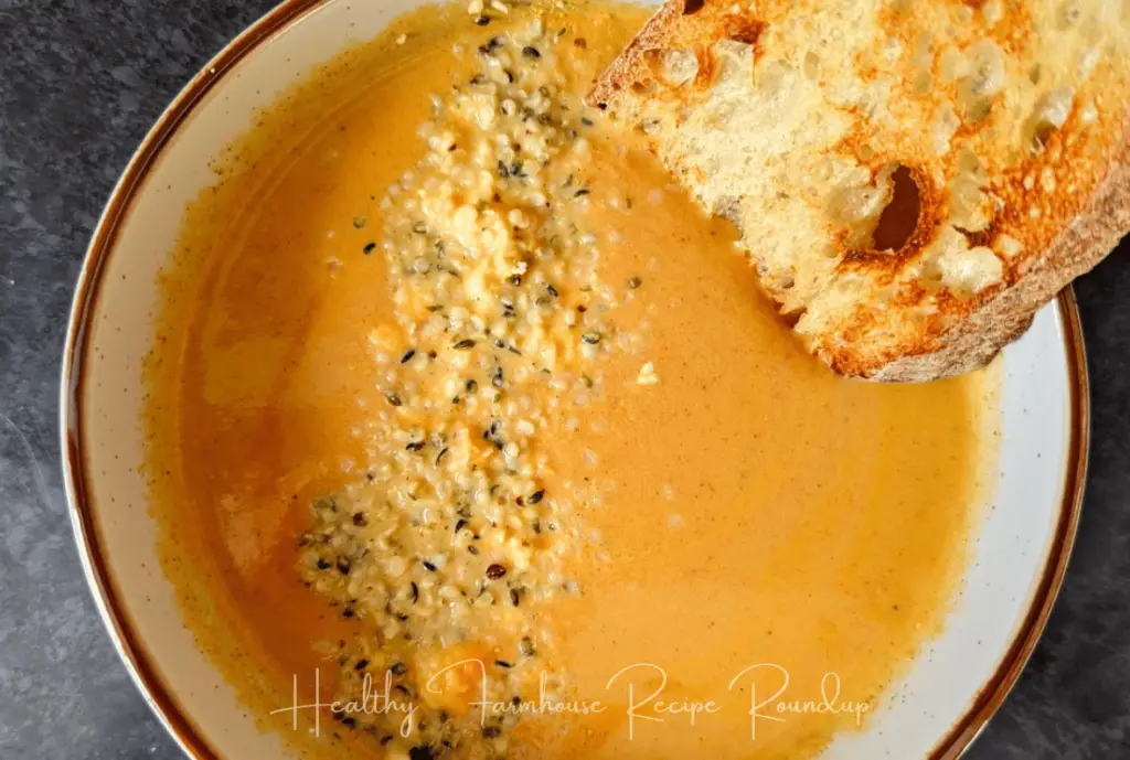 Bowl of soup with sprinkle of sesame seeds and a slice of toasted bread