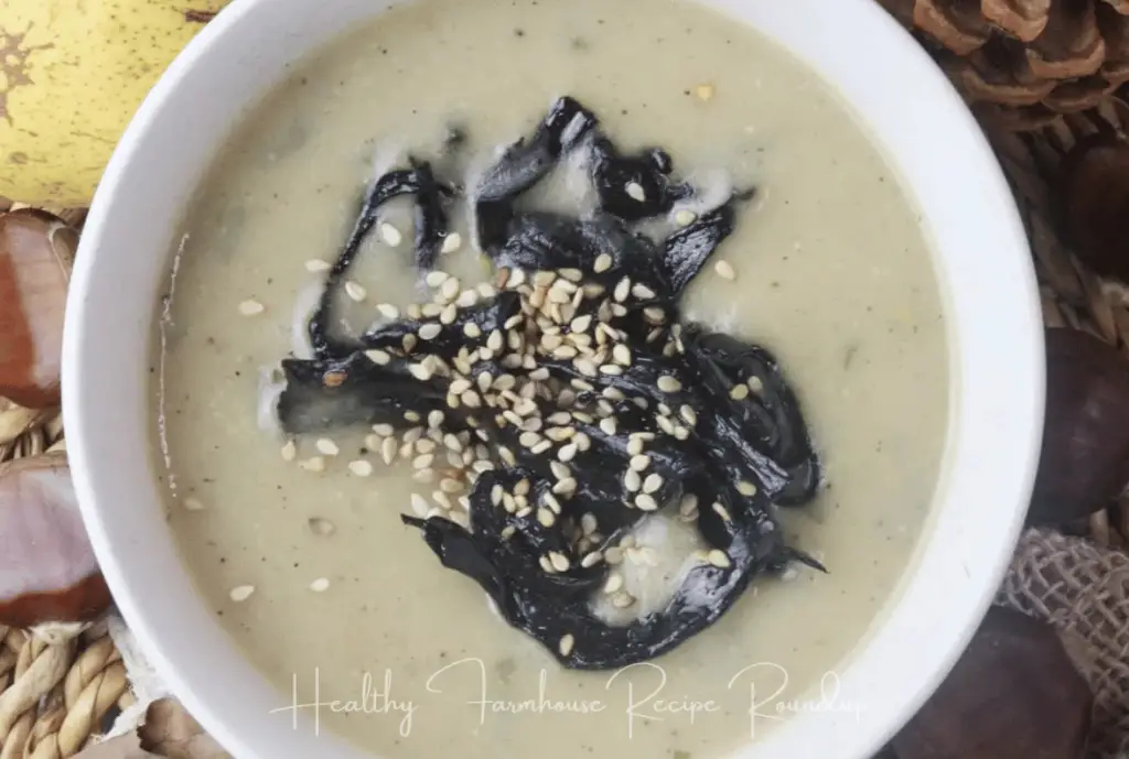 Unique fall soup - creamy white base, topped with black mushrooms and sesame seeds. Served in a white bowl.