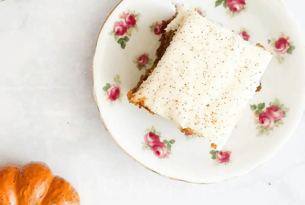 Square piece of pumpkin sheet cake on floral plate