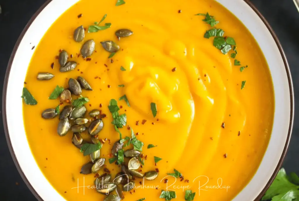 brightly colored pumpkin soup with herbs
