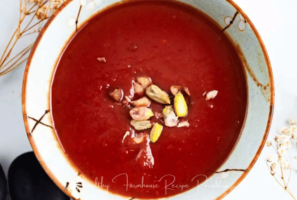 Easy fall soup - red colored soup base with pistachios on top.
