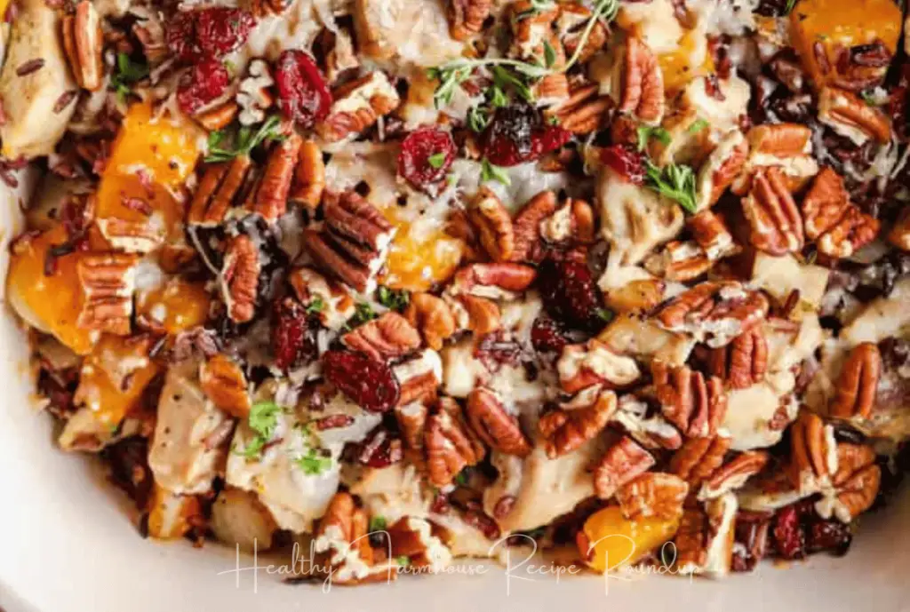 Casserole mixture with butternut squash, pecans, and herbs.