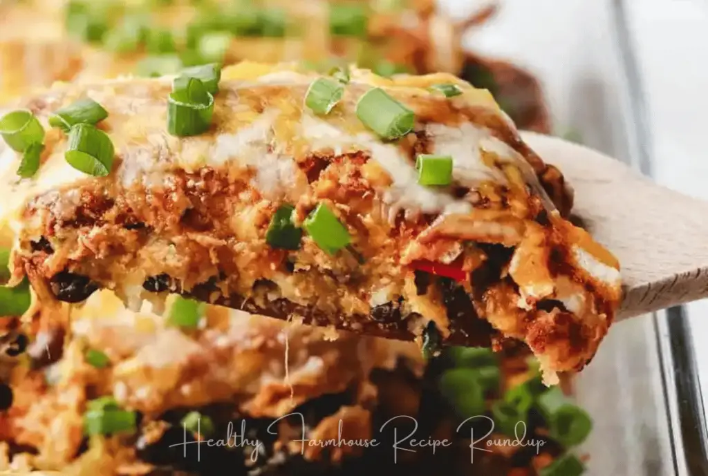 Slice of butternut squash enchiladas, topped with cheese and green onions