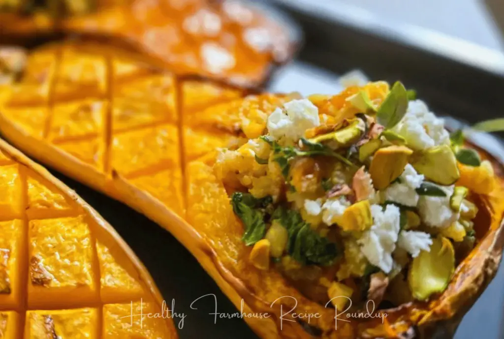 Butternut squash half filled with cheese and other fresh ingredients.