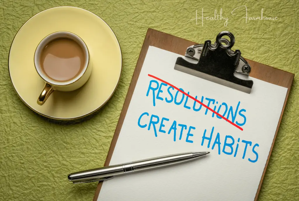 Clipboard with paper that reads: Resolutions (crossed out) Create Habits