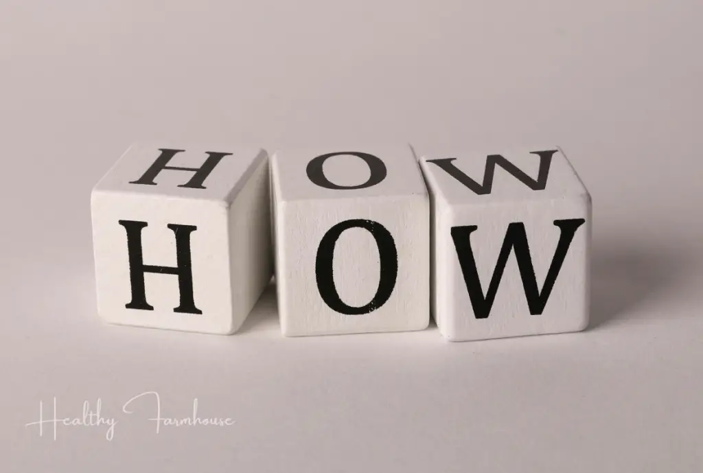 Black and white wooden blocks spelling HOW - working out throughout the day
