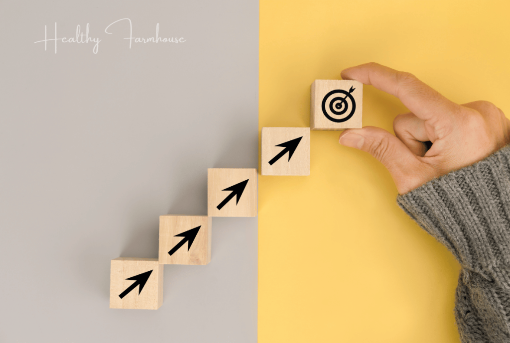 Wooden blocks creating stair steps to represent setting small reachable goals when learning how to start working out again.