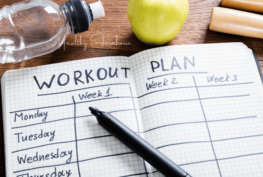 Handwritten workout plan on wooden surface with a green apple and water bottle