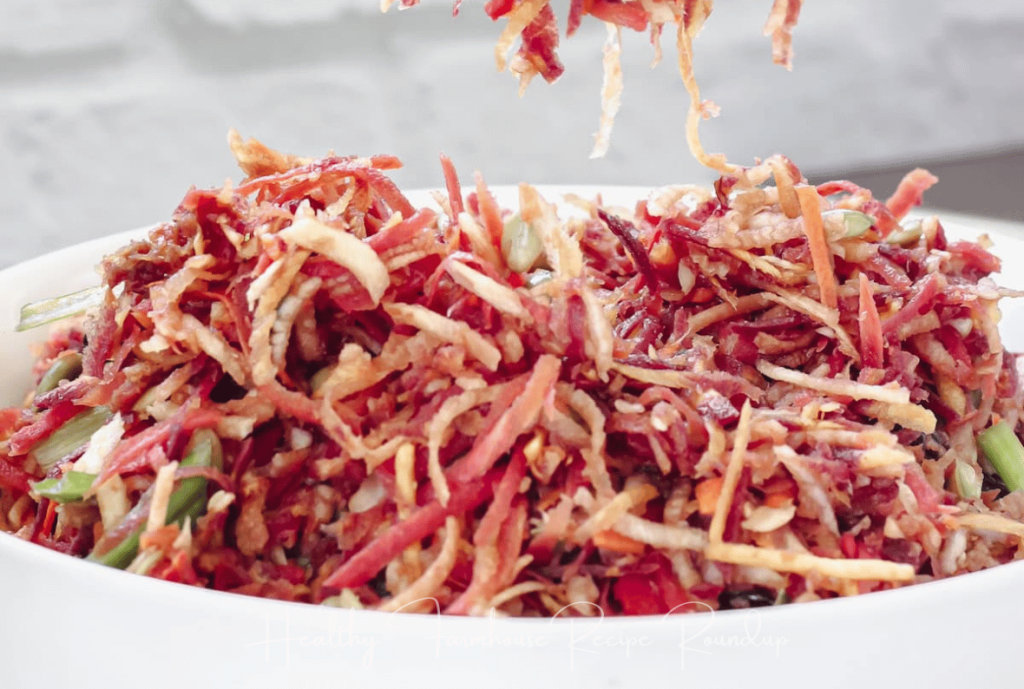 Shredded rainbow carrot summer coleslaw recipe in a white bowl