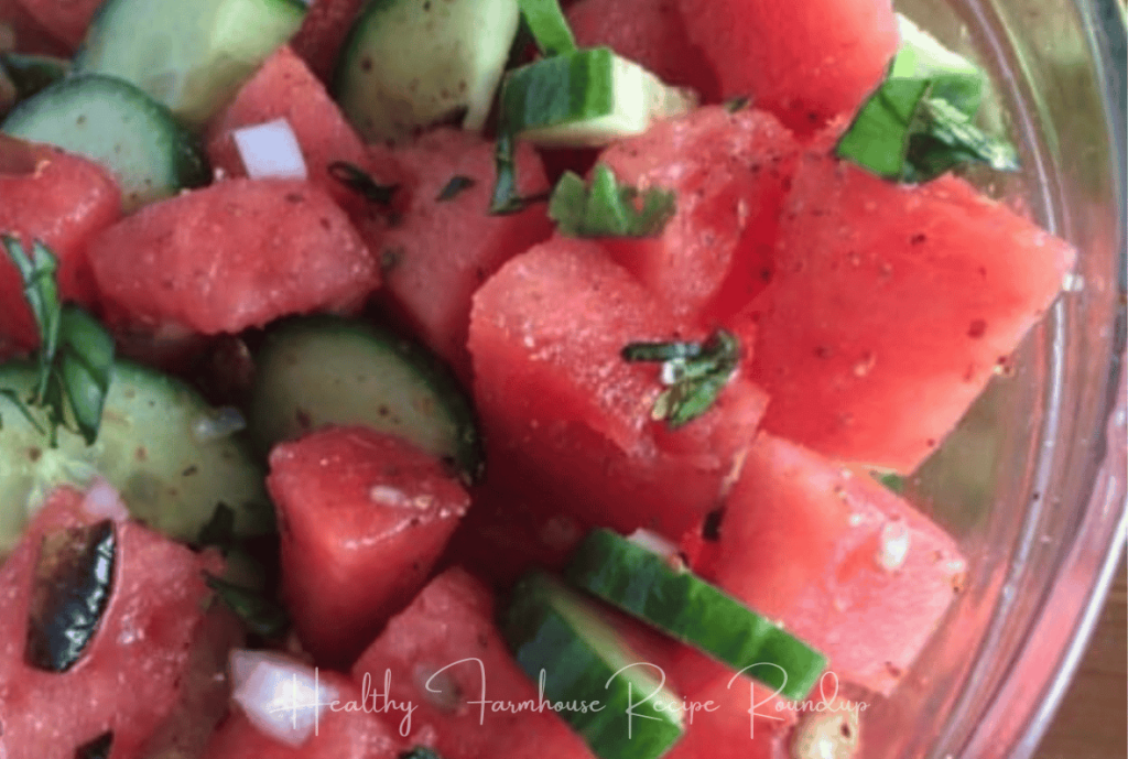 Red and green watermelon cucumber salad in a clear bowl